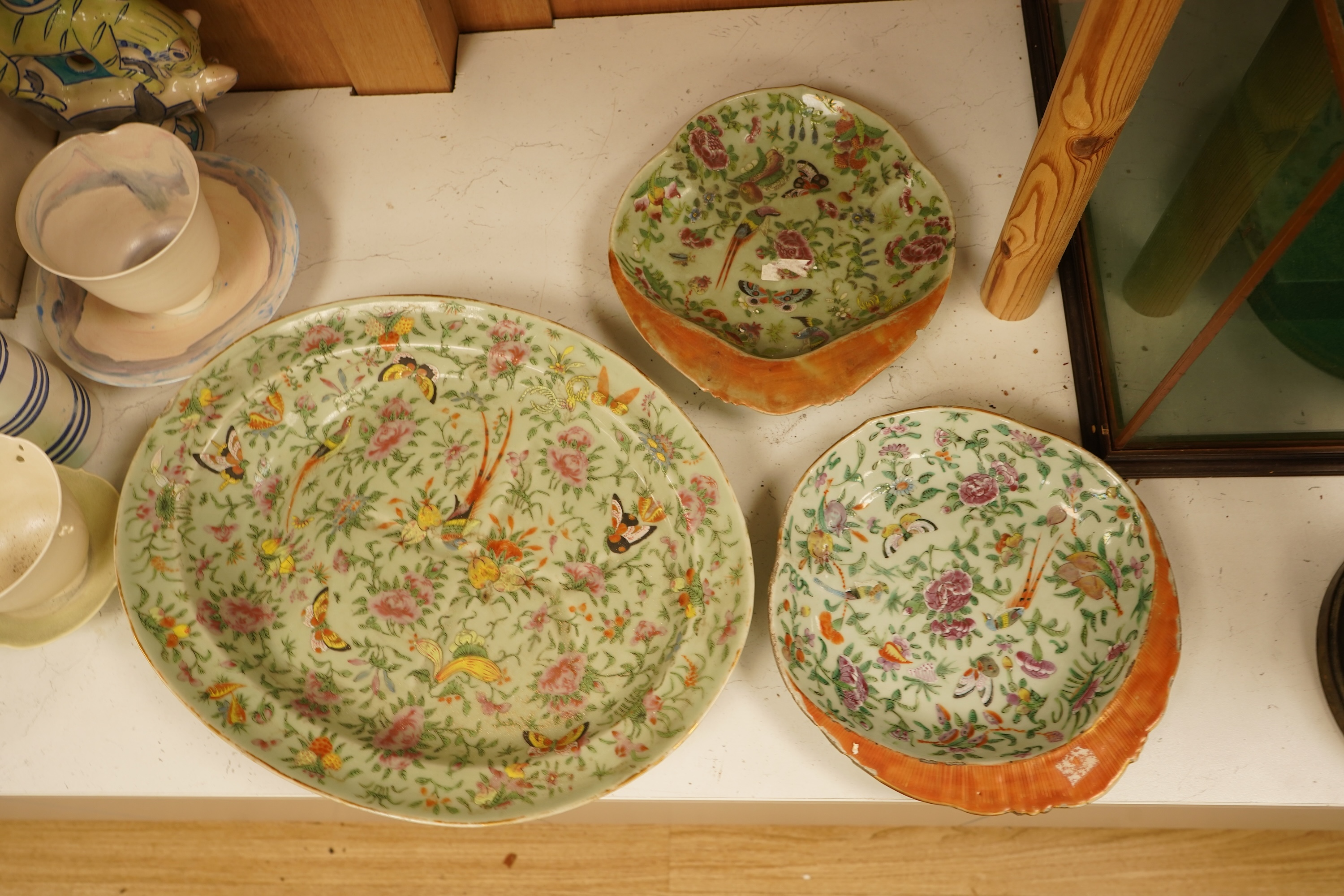 A Chinese celadon ground famille rose dish and two similar dessert dishes, c.1830, meat dish 42cm wide